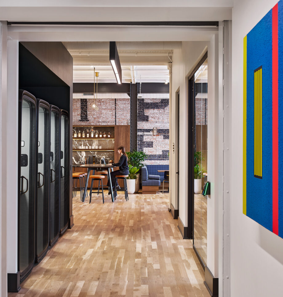 Modern corporate office hallway with exposed brick walls and hardwood floors in Detroit